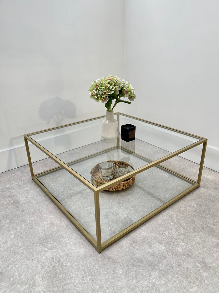 gold metal framed coffee table with glass top and shelf