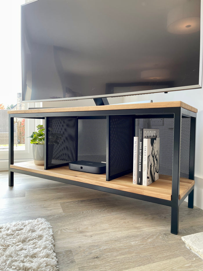 wooden and metal modern tv unit styled with books and a plant