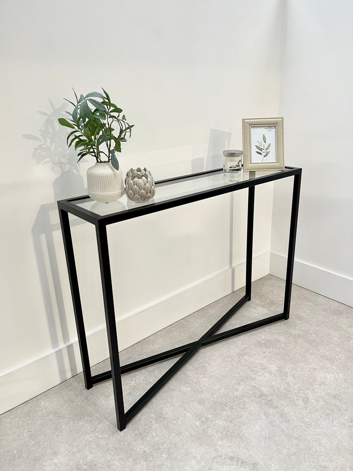 slim console table staged with a vase and picture frame