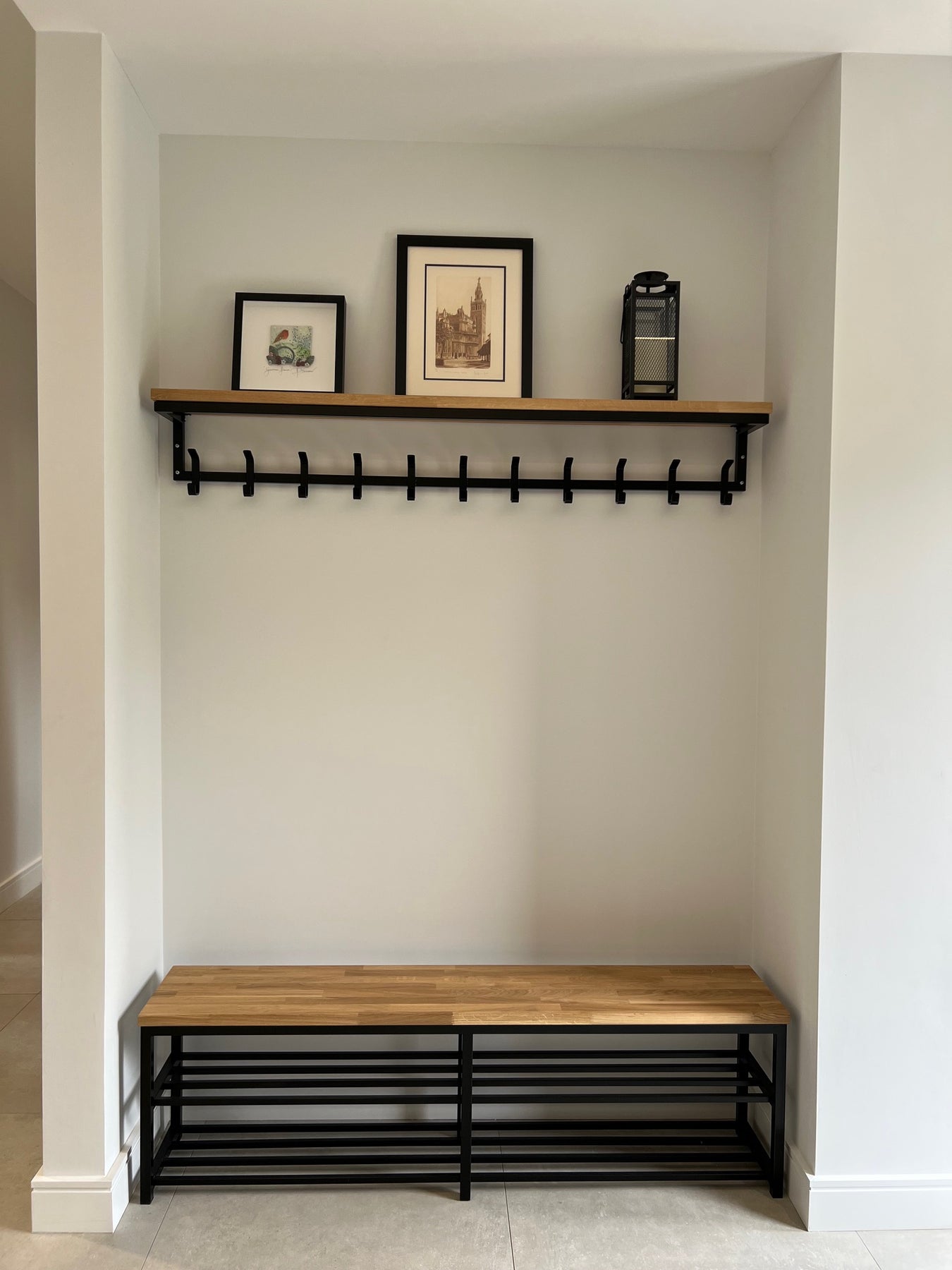 Modern interior design with black metal wall art and wooden cabinet.