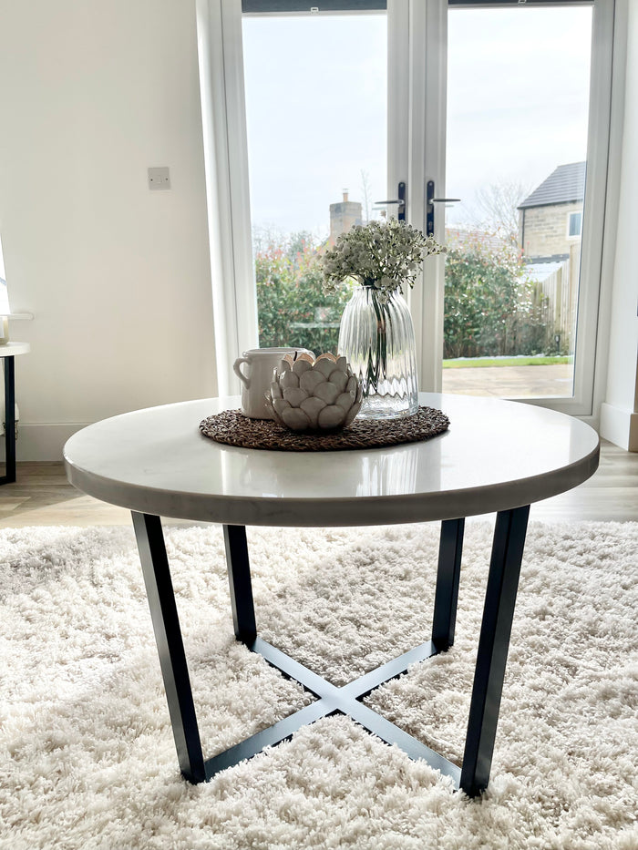 Staged round marble and black coffee table