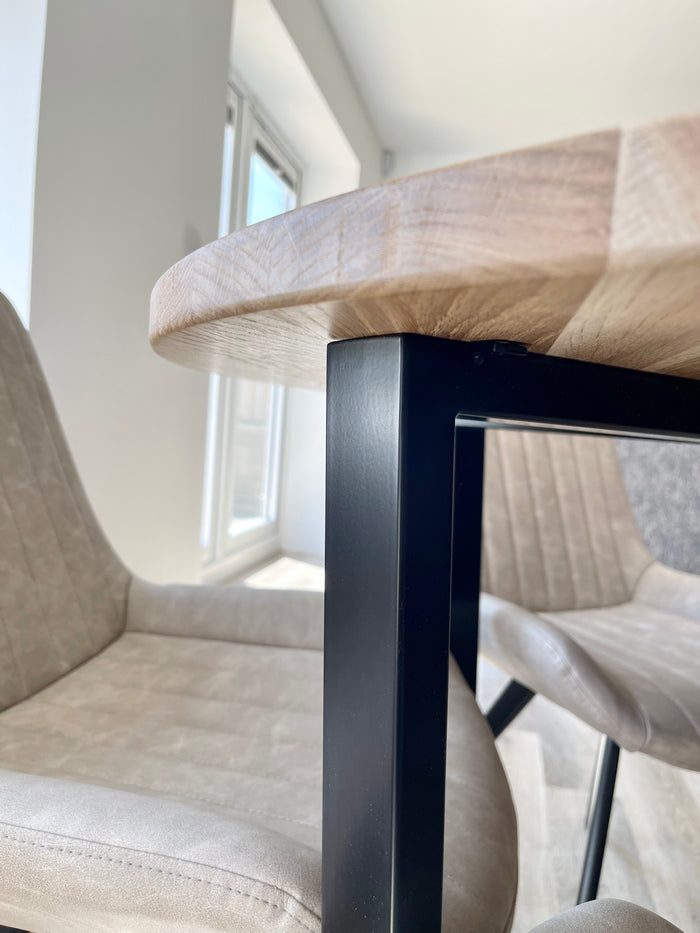 close up of dining room table with metal black legs