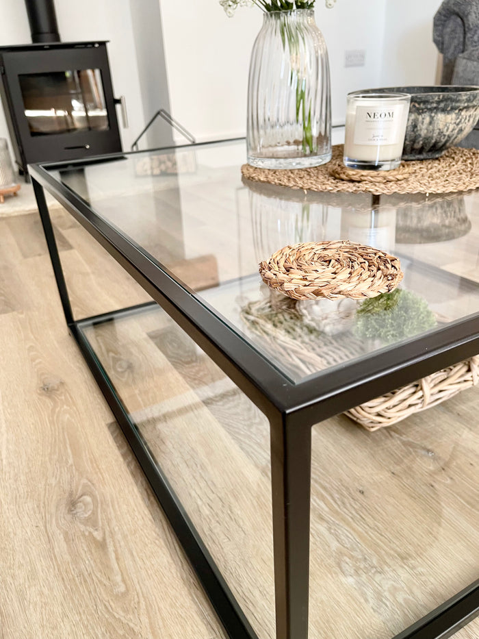 corner view of a bronze metal and glass  coffee table