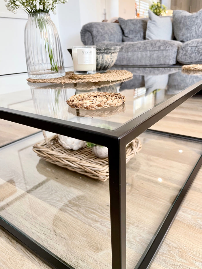corner view of metal and glass coffee table to show the detail