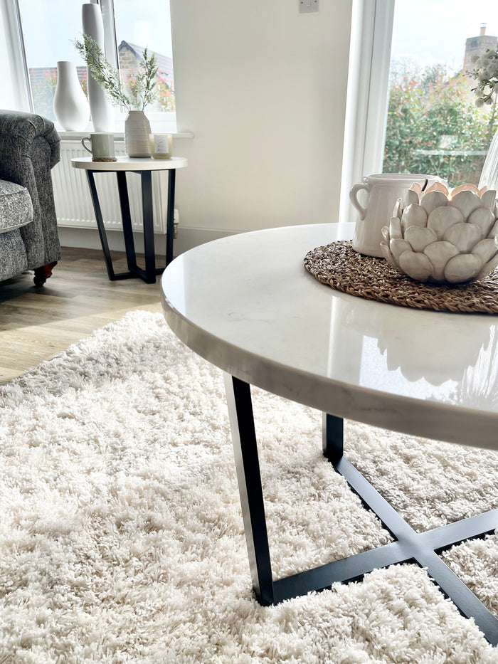 marble and black legged coffee table close up
