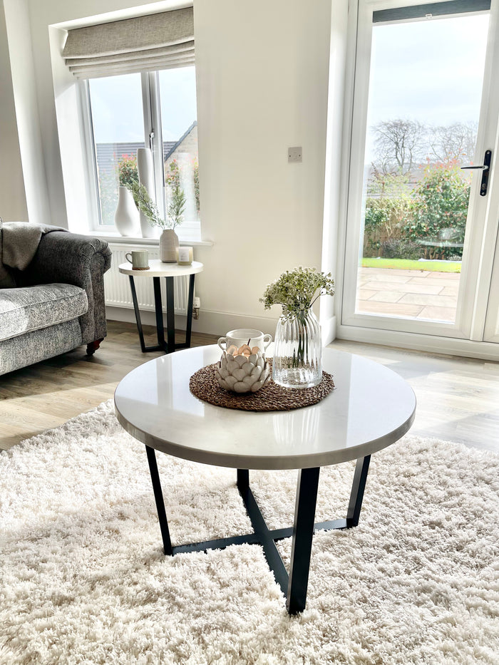 Marble and black round coffee table in a living room